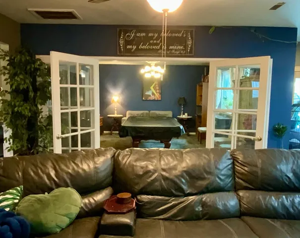 a living room with furniture a window and a flat screen tv