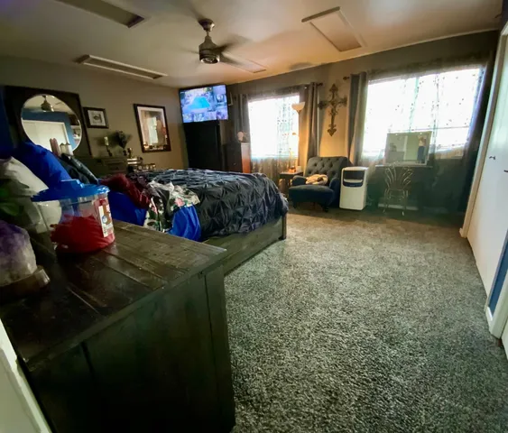 a bedroom with a bed and a bookshelf