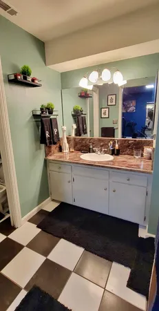 a room with a mirror and a lamp