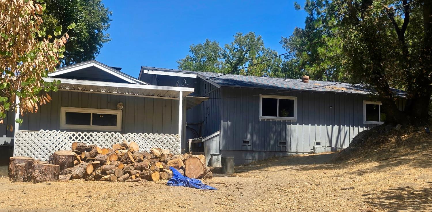 48833 Rock Point Road Oakhurst, CA 93644 - Photo 35 of 36 a front view of a house with a yard outdoor seating and covered with green space