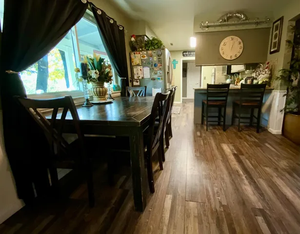 a living room with furniture a chandelier and a large window