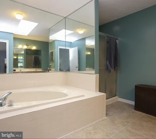 a spacious bathroom with a large tub and shower