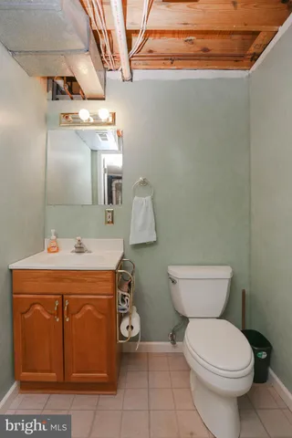 a bathroom with a toilet a sink and mirror