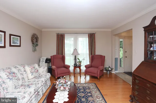 a living room with furniture couches and a flat tv screen