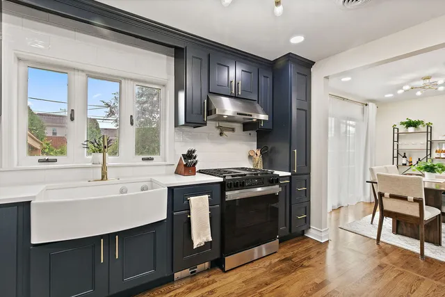 a kitchen with stainless steel appliances granite countertop a sink stove and refrigerator