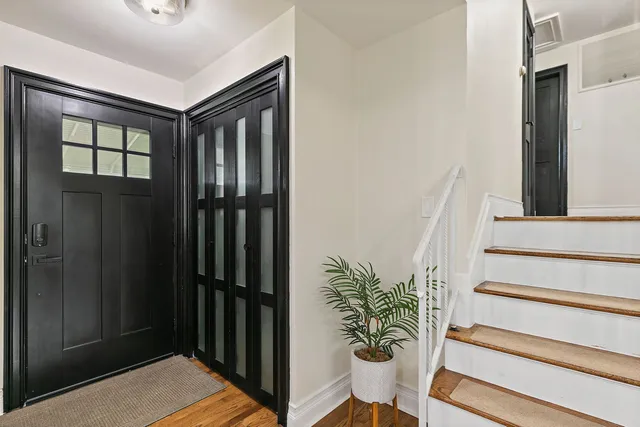 a view of entryway with a potted plant and wooden floor