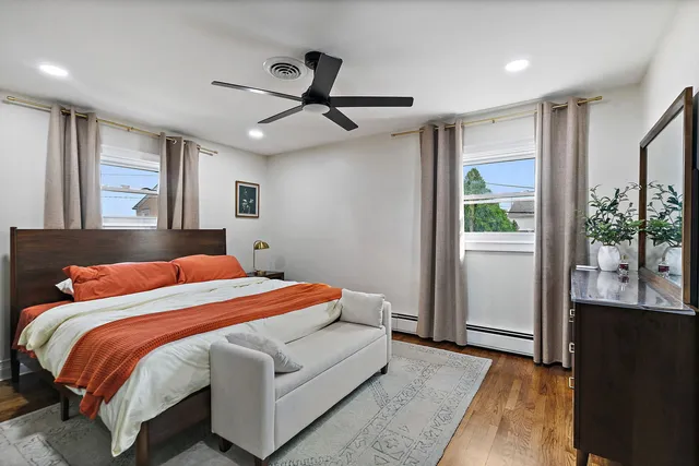 a bedroom with a large bed and a chandelier