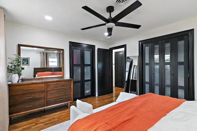 a bedroom with a large bed and a dresser