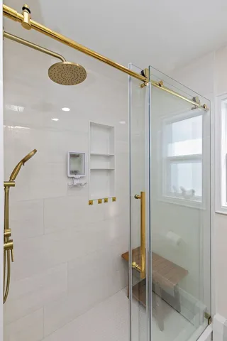 a bathroom with a shower and a glass door