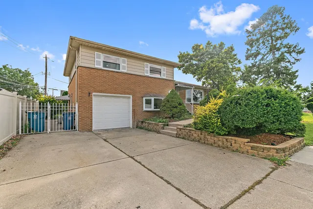 a front view of a house with plants