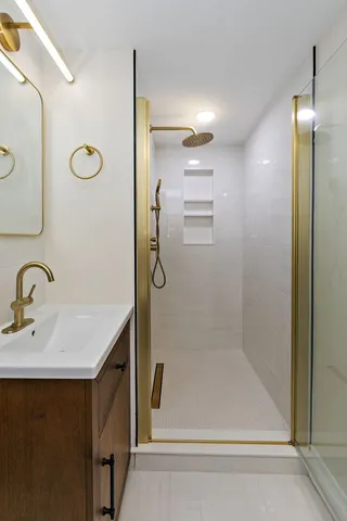 a bathroom with a shower sink and mirror
