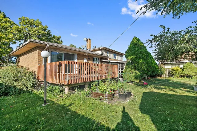 a view of a chair and table in the garden