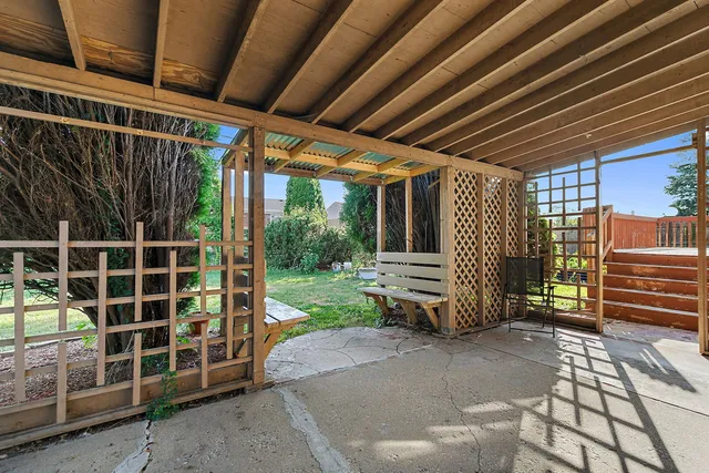 a view of a backyard with wooden fence