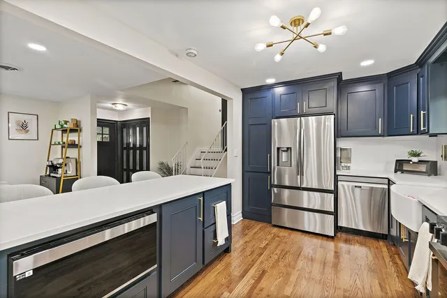a kitchen with refrigerator cabinets and wooden floor