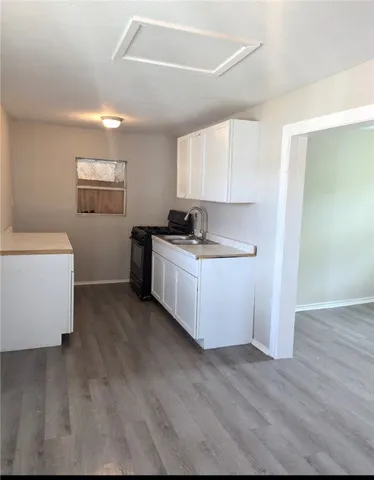 a kitchen with a cabinets and wooden floor
