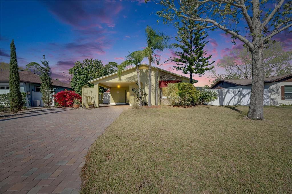 10719 Drummond Road Tampa, FL 33615 - Photo 1 of 1 a front view of a house with a yard and garage