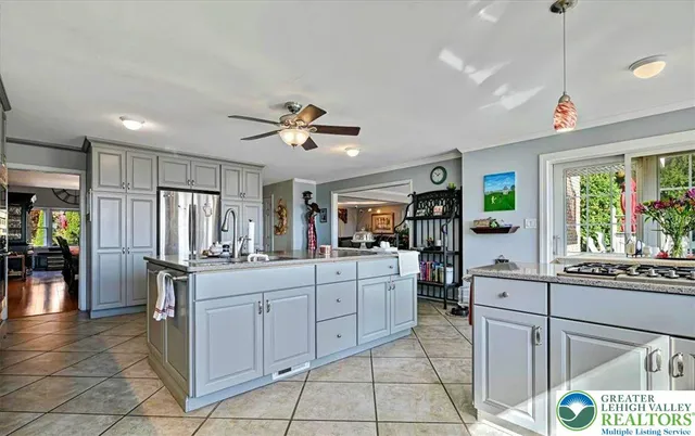 a living room with furniture a rug a fireplace and a large window