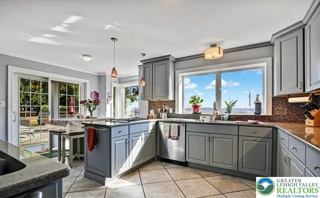 a dinning area with chandelier and wooden floor