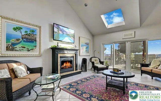 a living room with furniture a fireplace and a flat screen tv
