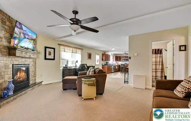 a living room with furniture a flat screen tv and a fireplace