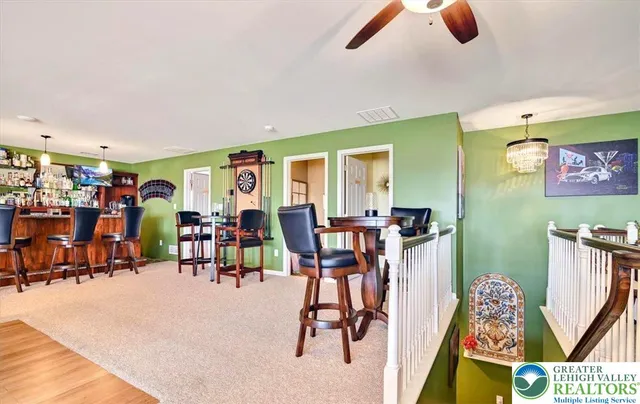 a kitchen with granite countertop a table chairs microwave and cabinets