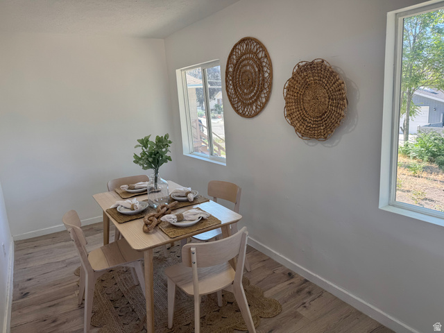 47 B Street Helper, UT 84526 - Photo 2 of 19 Bright dining area featuring light wood-finish flooring and multiple windows