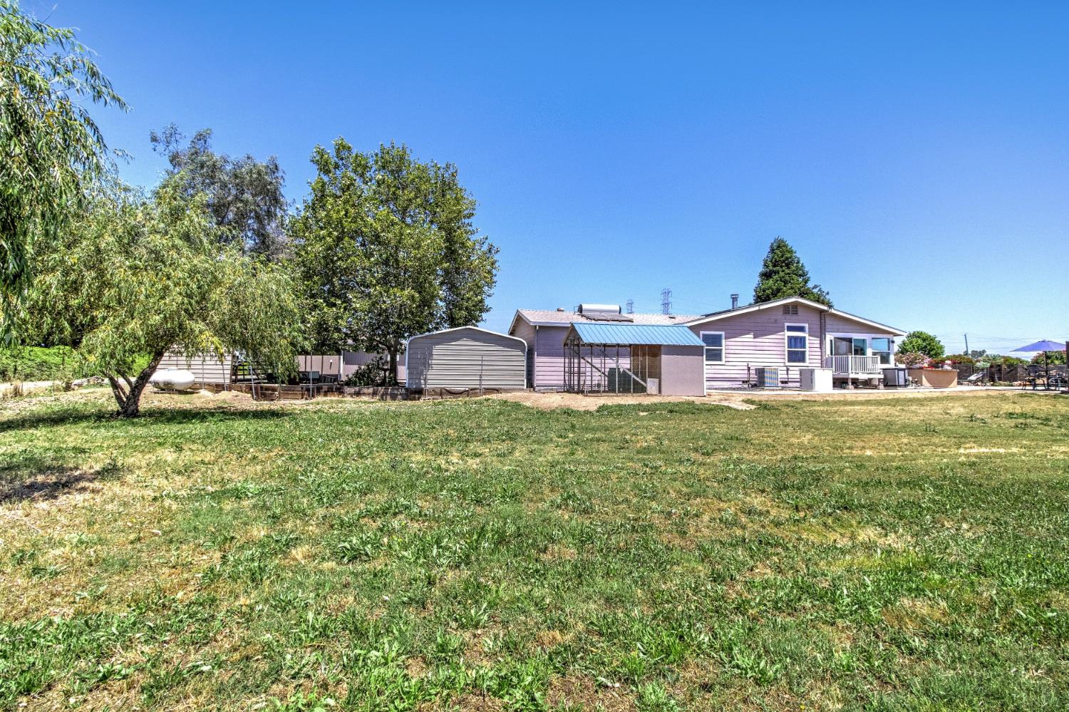 12390 Hobday Road Wilton, CA 95693 - Photo 65 of 92 a view of house with outdoor space and garden