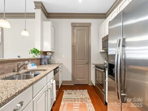 a kitchen with stainless steel appliances granite countertop a refrigerator stove and microwave