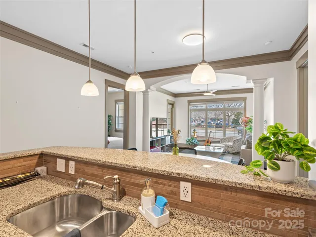 a kitchen with stainless steel appliances granite countertop a refrigerator a stove and a sink