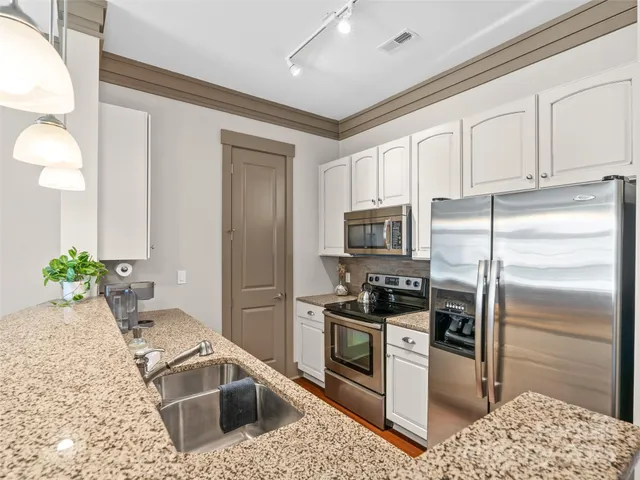 a kitchen with a stove and cabinets