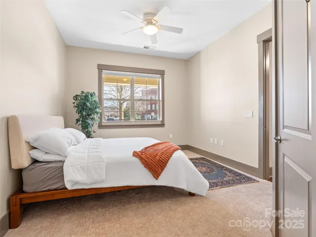 a bedroom with a bed and a potted plant