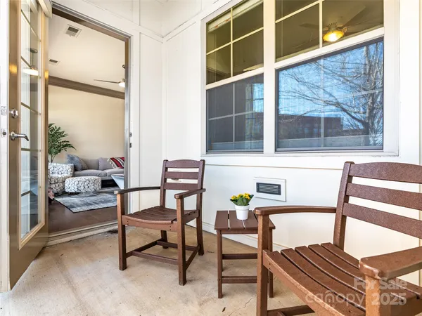 a balcony with table and chairs