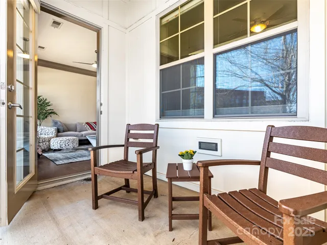a balcony with table and chairs