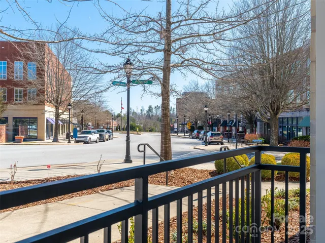 a view of a house with a large window and wooden fence