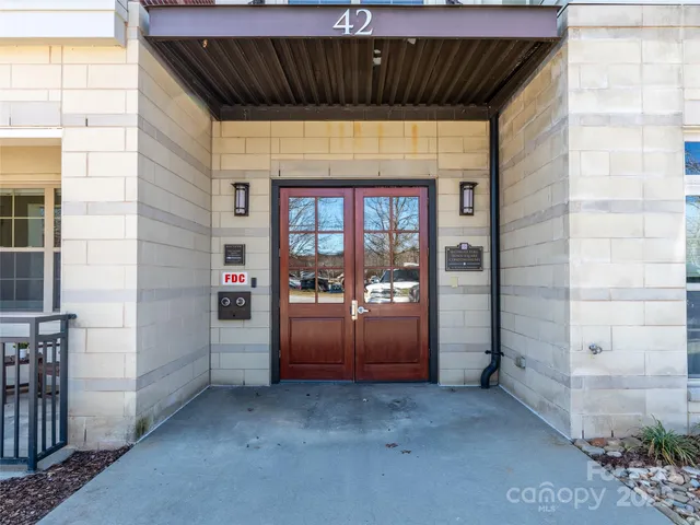 a view of a building with a bench in the patio