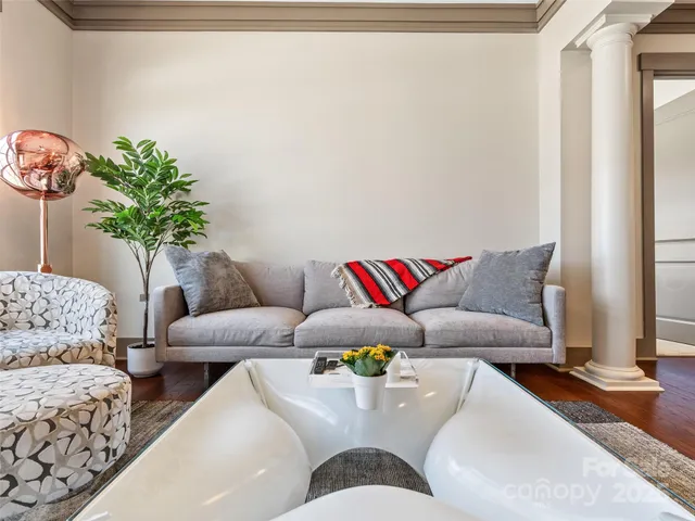 a living room with furniture and wooden floor