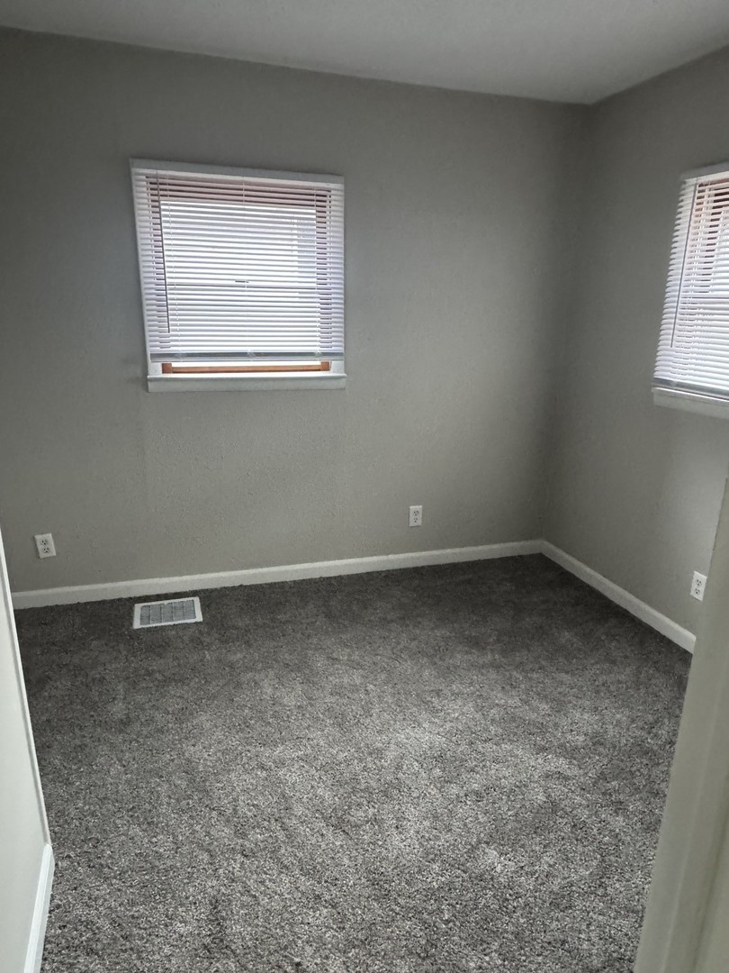 108 East Cleveland Street Heyworth, IL 61745 - Photo 8 of 13 an empty room with a window