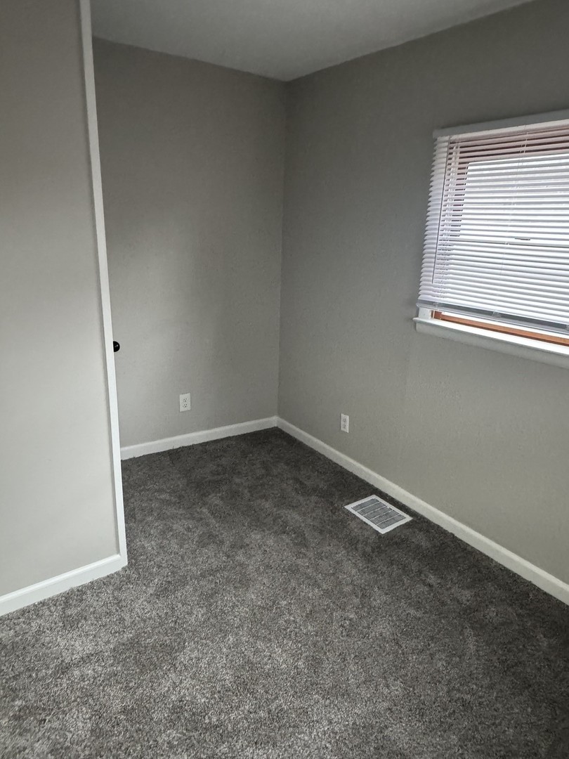 108 East Cleveland Street Heyworth, IL 61745 - Photo 10 of 13 an empty room with a window