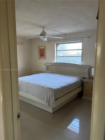 a bathroom with a granite countertop sink and a toilet