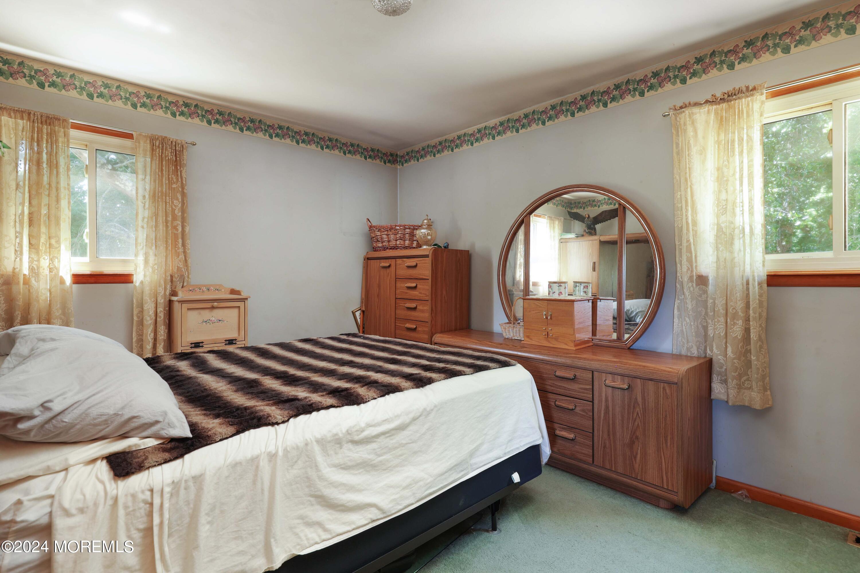 262 Cedar Swamp Road Jackson, NJ 08527 - Photo 11 of 28 a bedroom with a bed a mirror on dresser and a window