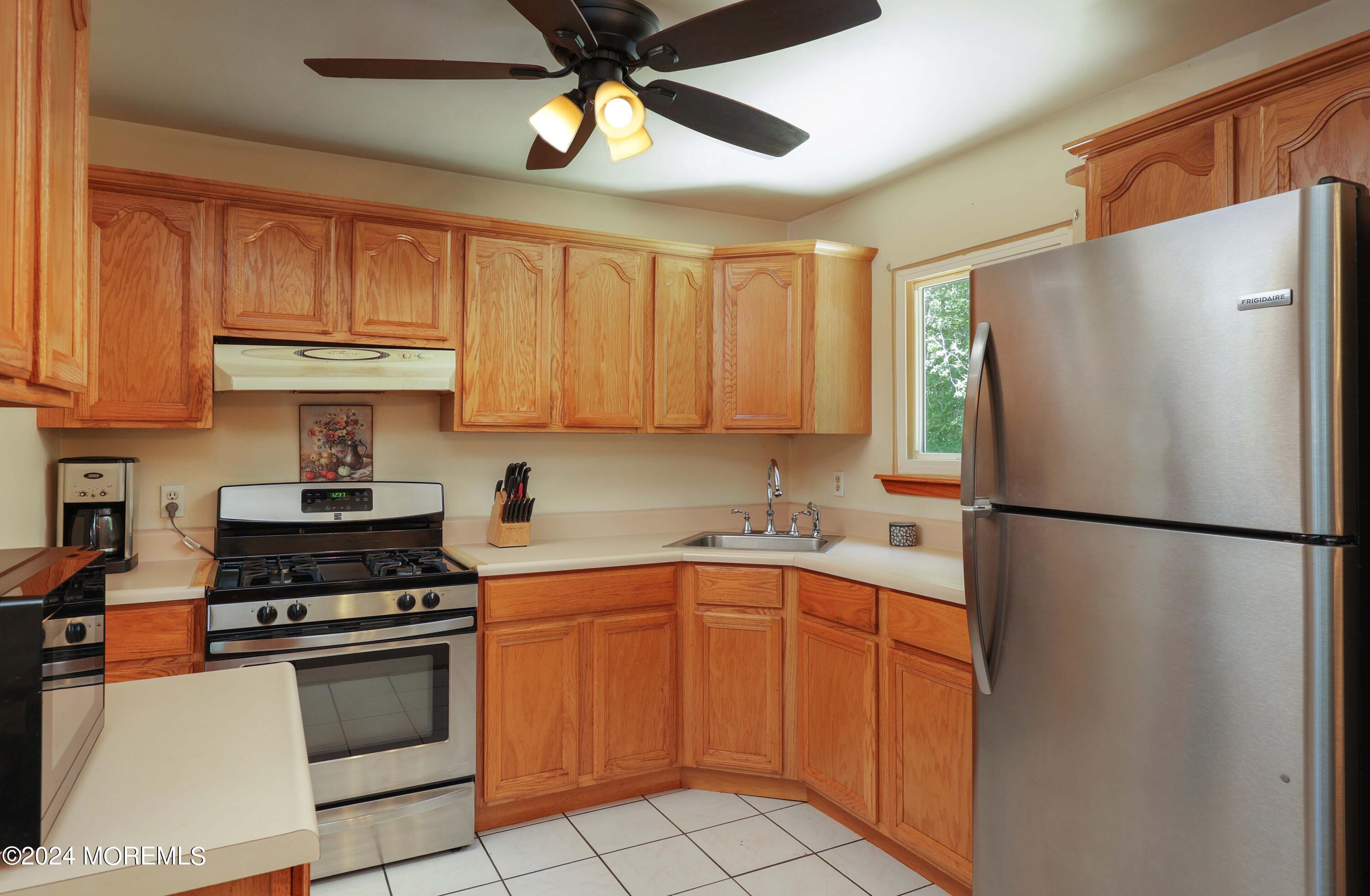 262 Cedar Swamp Road Jackson, NJ 08527 - Photo 8 of 28 a kitchen with a refrigerator a sink and cabinets