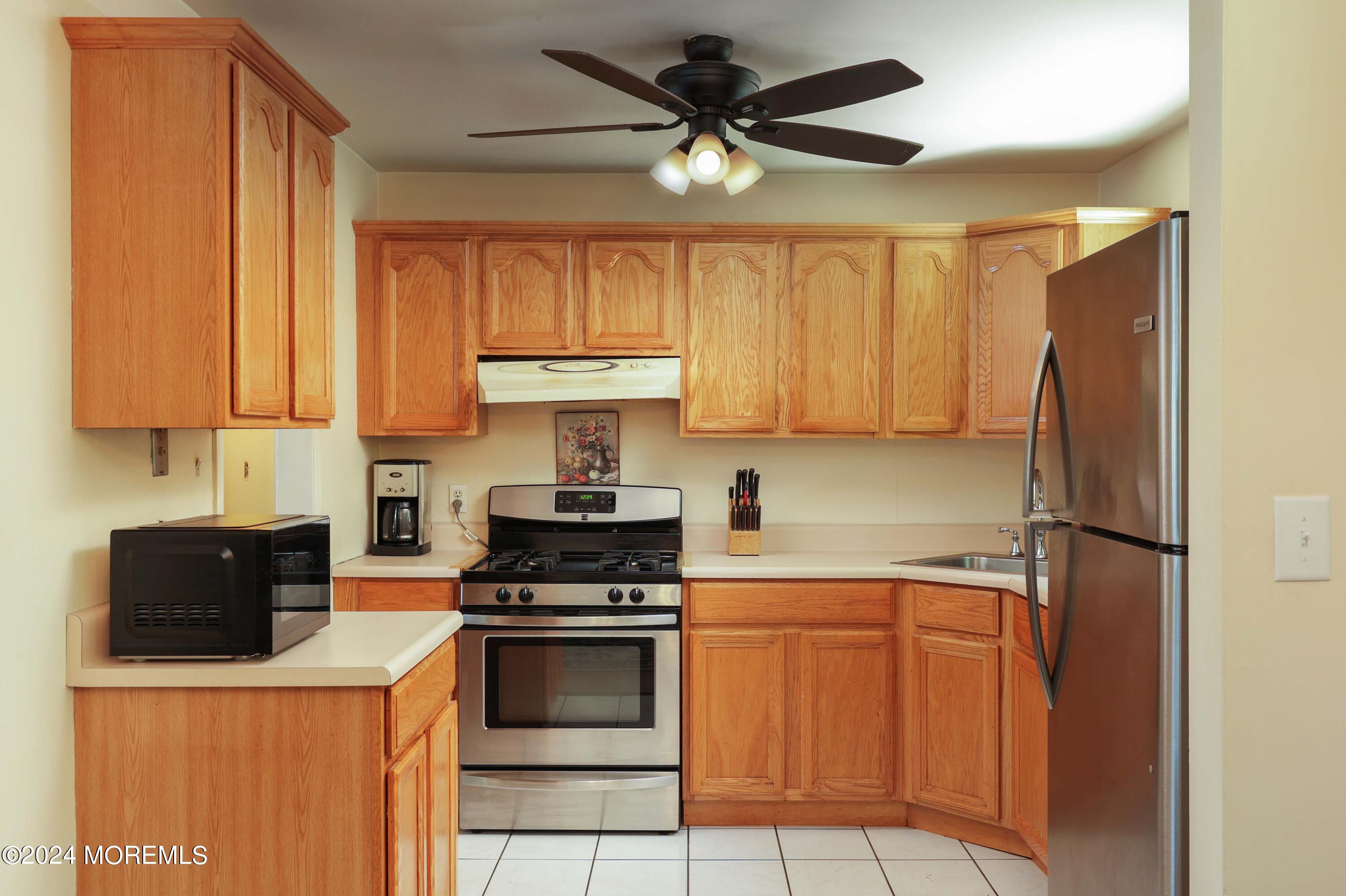 262 Cedar Swamp Road Jackson, NJ 08527 - Photo 9 of 28 a kitchen with stainless steel appliances a refrigerator sink and cabinets