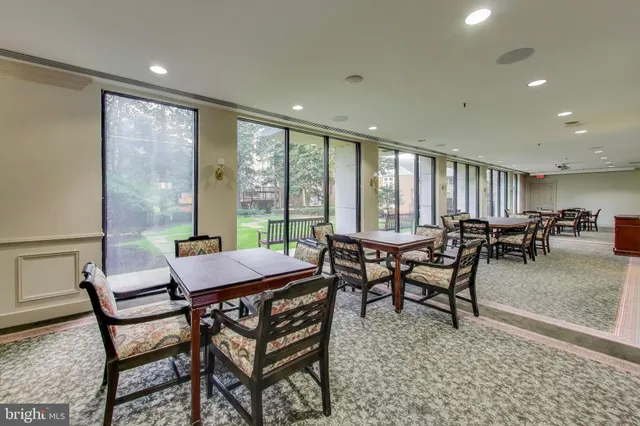 a walk in closet with wooden floor