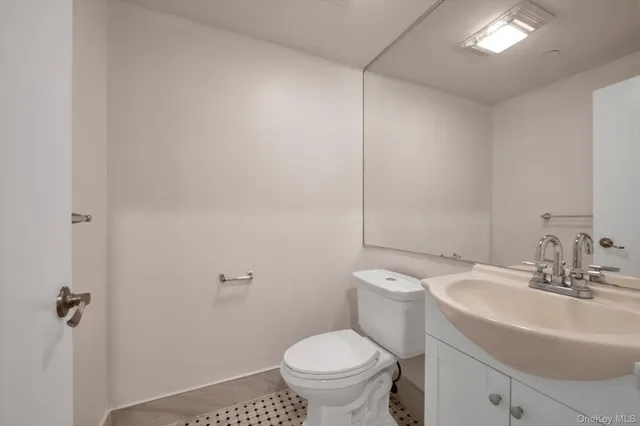 a bathroom with a sink toilet and a mirror