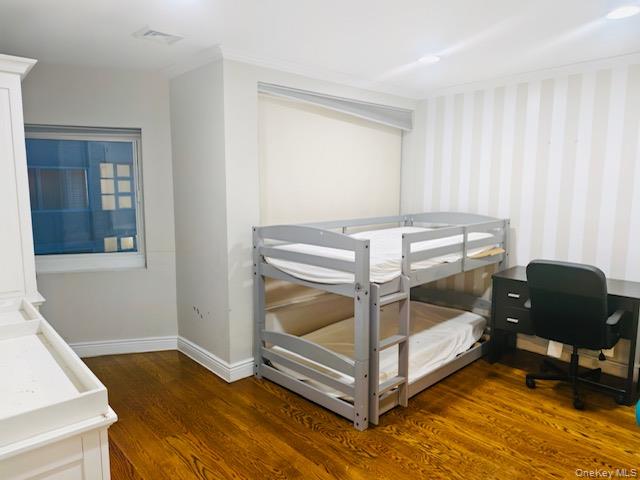 100 Cutter Mill Road, Unit 4G Great Neck, NY 11021 - Photo 14 of 18 Bedroom featuring dark wood-style floors, wallpapered walls, and ornamental molding