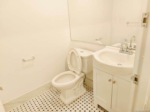 100 Cutter Mill Road, Unit 4G Great Neck, NY 11021 - Photo 17 of 18 Half bathroom with vanity and light tile patterned floors