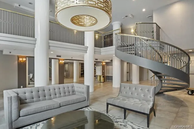 a living room with furniture and a chandelier