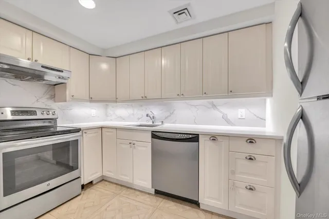 a kitchen with cabinets appliances and a sink