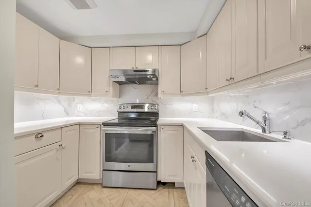 a kitchen with a sink stove and cabinets