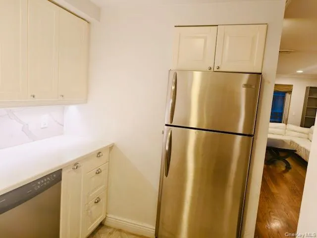 a view of a kitchen with a refrigerator